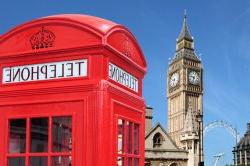 Photo of traditional red telephone box with Big Ben out of focus in the background.